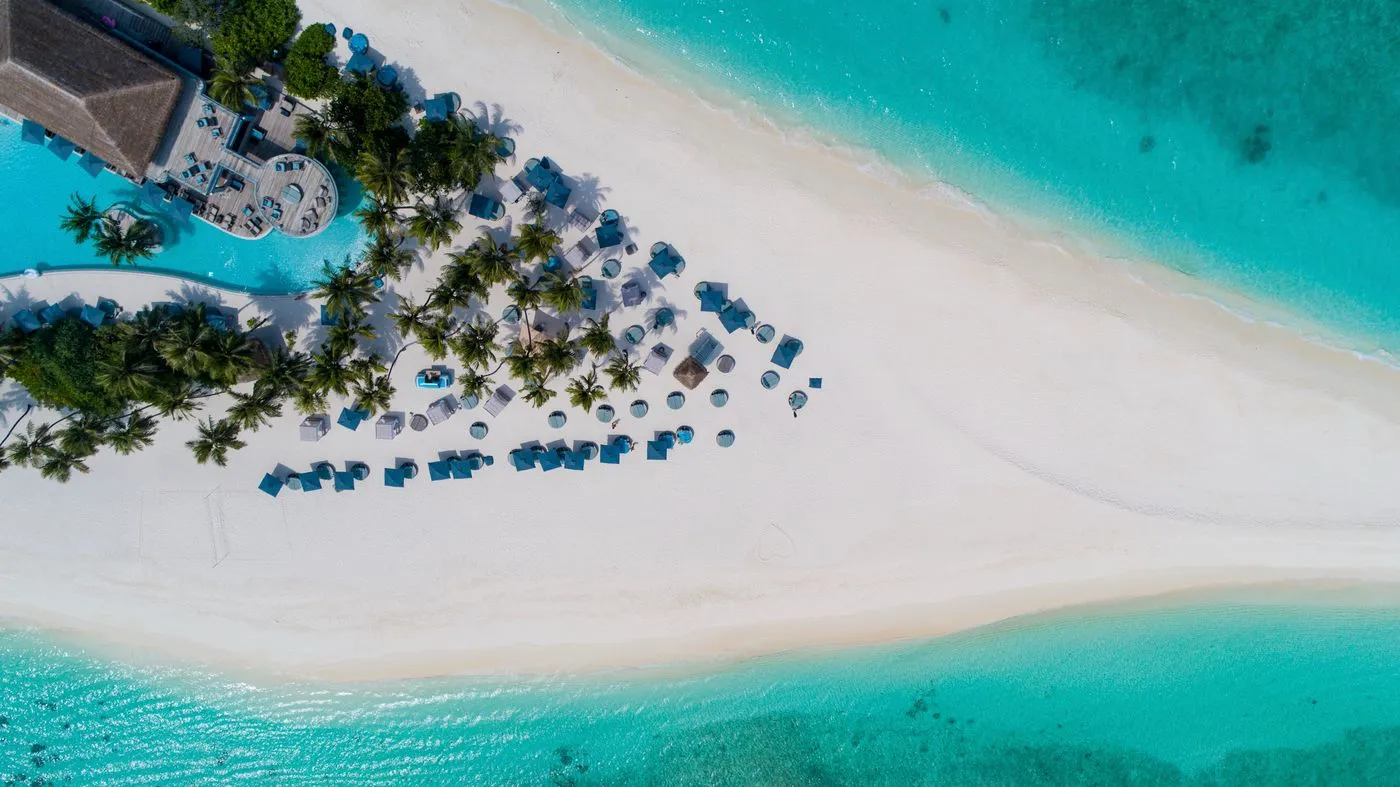 Representative view of white sand, palms and turquoise water
